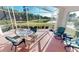 Peaceful screened lanai with lake view and outdoor furniture at 10208 Arrowhead Dr, Punta Gorda, FL 33955