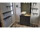 Bathroom with vessel sink, floating shelves, and wood vanity at 1108 Ample Ave, Port Charlotte, FL 33948