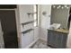 Bathroom featuring a modern vanity, vessel sink, and a shower with glass doors plus decorative shelving for storage at 1108 Ample Ave, Port Charlotte, FL 33948