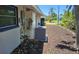 Exterior side view of home with landscaping, AC unit, and mulch at 1108 Ample Ave, Port Charlotte, FL 33948