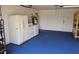 Spacious garage with blue floor, laundry machines, and storage options at 1108 Ample Ave, Port Charlotte, FL 33948