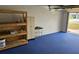 Garage with blue flooring, with multiple storage options and open access at 1108 Ample Ave, Port Charlotte, FL 33948