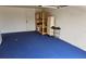 Clean, spacious garage interior with blue flooring, shelving, and ample storage space for vehicles and tools at 1108 Ample Ave, Port Charlotte, FL 33948