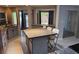 Well-lit kitchen featuring an island with a granite countertop and seating for three at 1108 Ample Ave, Port Charlotte, FL 33948