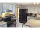 Modern kitchen with black appliances and granite counters at 1108 Ample Ave, Port Charlotte, FL 33948