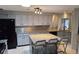 Well-lit kitchen featuring an island with a granite countertop and seating for three at 1108 Ample Ave, Port Charlotte, FL 33948