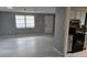 Neutral living room with window, door and view of kitchen area with granite countertops at 1108 Ample Ave, Port Charlotte, FL 33948