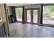 Well-lit living room area featuring three expansive windows with lush backyard views at 1108 Ample Ave, Port Charlotte, FL 33948