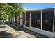 Enclosed patio with screens, table and chairs, and access to backyard at 1108 Ample Ave, Port Charlotte, FL 33948