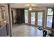 Sunroom with tiled floor, access to backyard, and workout equipment at 1108 Ample Ave, Port Charlotte, FL 33948