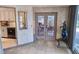 Sunroom provides a bright transition with double doors to an outdoor view; features access to kitchen and a view of exterior at 1108 Ample Ave, Port Charlotte, FL 33948