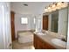 Bathroom with double sinks, large bathtub, and a separate shower at 12415 Catalina Dr, Punta Gorda, FL 33955
