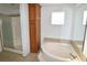 Bathroom with a shower and tub combo, linen cabinet, and tile floor at 12415 Catalina Dr, Punta Gorda, FL 33955