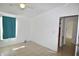 Bedroom with tile floors, ceiling fan and teal curtain at 12415 Catalina Dr, Punta Gorda, FL 33955