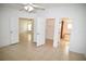 Bright bedroom with tile floors, ceiling fan, and access to a large closet and bathroom at 12415 Catalina Dr, Punta Gorda, FL 33955