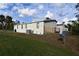 Single-wide mobile home with detached shed and satellite dish at 12415 Catalina Dr, Punta Gorda, FL 33955