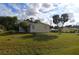 Mobile home with a spacious yard and palm trees at 12415 Catalina Dr, Punta Gorda, FL 33955