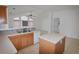 Kitchen with island, wood cabinets, and views into living area at 12415 Catalina Dr, Punta Gorda, FL 33955
