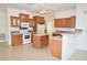 Kitchen boasts ample wood cabinets and an island at 12415 Catalina Dr, Punta Gorda, FL 33955