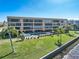 Condo building exterior, showcasing waterfront pool and landscaping at 1601 Park Beach Cir # 112/2, Punta Gorda, FL 33950