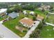 Aerial view of a single-Gathering home with a large yard and detached structures at 1713 Belvidere Rd, Englewood, FL 34223