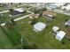 Aerial view of property with a house, detached garage, shed and large yard at 1713 Belvidere Rd, Englewood, FL 34223