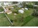 Aerial view of a home with a large backyard, detached garage and shed at 1713 Belvidere Rd, Englewood, FL 34223