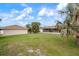 Large backyard with a detached building and grassy area at 1713 Belvidere Rd, Englewood, FL 34223