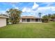 Large backyard with a screened patio and lush grass at 1713 Belvidere Rd, Englewood, FL 34223