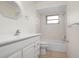 Clean bathroom with white vanity, tub, and tiled walls at 1713 Belvidere Rd, Englewood, FL 34223