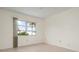 Empty bedroom with tile flooring and a window with a view of palm trees at 1713 Belvidere Rd, Englewood, FL 34223