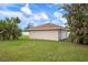 Detached garage with a single car garage door at 1713 Belvidere Rd, Englewood, FL 34223