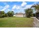 Detached garage with a single door and a grassy area at 1713 Belvidere Rd, Englewood, FL 34223