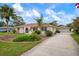 House with a paved driveway and landscaping at 1713 Belvidere Rd, Englewood, FL 34223
