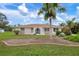 Single story home with palm trees and landscaped yard at 1713 Belvidere Rd, Englewood, FL 34223