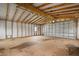 Large unfinished garage with high ceilings and wood beams at 1713 Belvidere Rd, Englewood, FL 34223