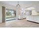 Kitchen features white cabinets and sliding door access at 1713 Belvidere Rd, Englewood, FL 34223