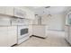 Kitchen with white cabinets and island at 1713 Belvidere Rd, Englewood, FL 34223