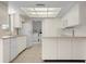 White kitchen with island and laundry access at 1713 Belvidere Rd, Englewood, FL 34223