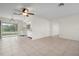 Open living and dining area with tile flooring and kitchen access at 1713 Belvidere Rd, Englewood, FL 34223