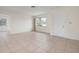Bright living room with tile floors and access to other rooms at 1713 Belvidere Rd, Englewood, FL 34223