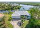 Aerial view of waterfront home with private dock and lush landscaping at 18138 Petoskey Cir, Port Charlotte, FL 33948
