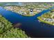 Wide aerial view of waterfront home and neighborhood at 18138 Petoskey Cir, Port Charlotte, FL 33948