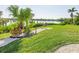 Landscaped backyard with lush greenery and waterfront access at 18138 Petoskey Cir, Port Charlotte, FL 33948