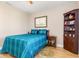 Bedroom with teal bedding, wood floors, and corner cabinet at 18138 Petoskey Cir, Port Charlotte, FL 33948