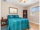Cozy bedroom with teal bedding and wood flooring at 18138 Petoskey Cir, Port Charlotte, FL 33948