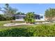 Cute house exterior with a well-manicured lawn and tropical plants at 18138 Petoskey Cir, Port Charlotte, FL 33948
