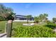 Charming house exterior with lush landscaping and waterfront views at 18138 Petoskey Cir, Port Charlotte, FL 33948