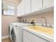 Laundry room with washer, dryer, and utility sink at 18138 Petoskey Cir, Port Charlotte, FL 33948