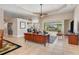 Open living room with wood furniture, and view of pool and canal at 18138 Petoskey Cir, Port Charlotte, FL 33948